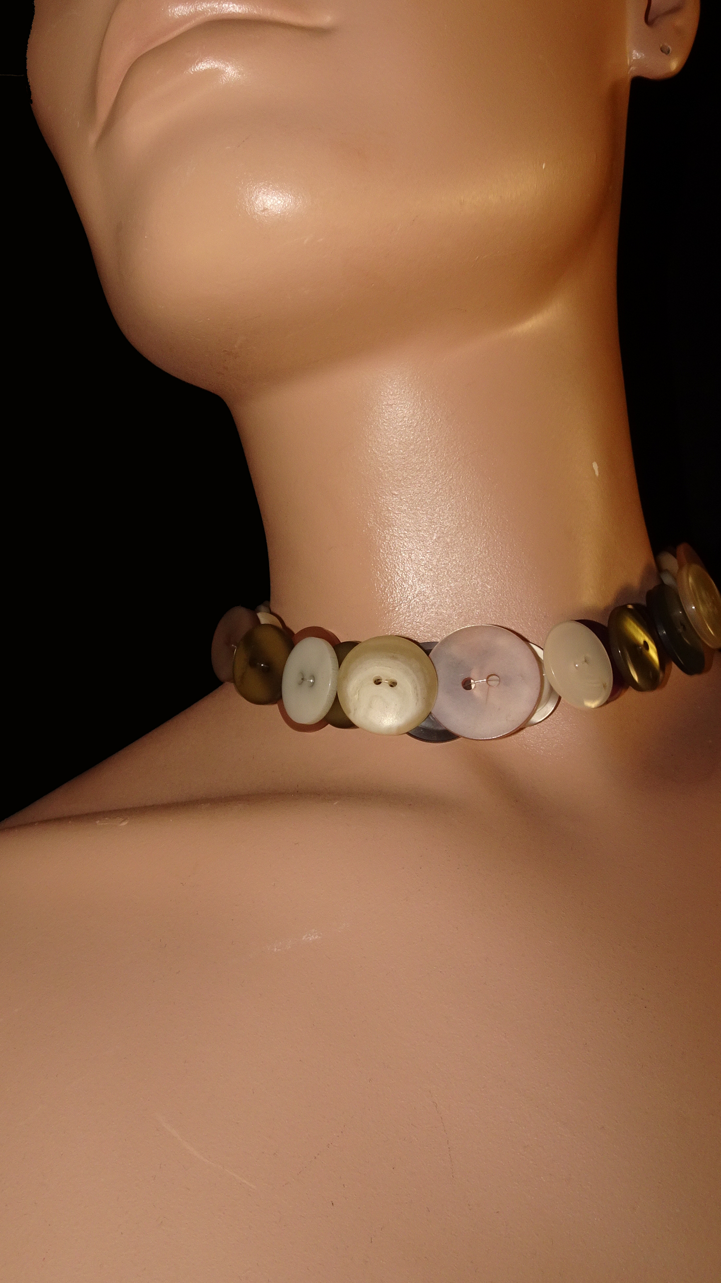 Handmade weARCHIVE choker made of vintage buttons in ivory, peach, burgundy, and metallic tones. Upcycled design with a soft, nostalgic palette.