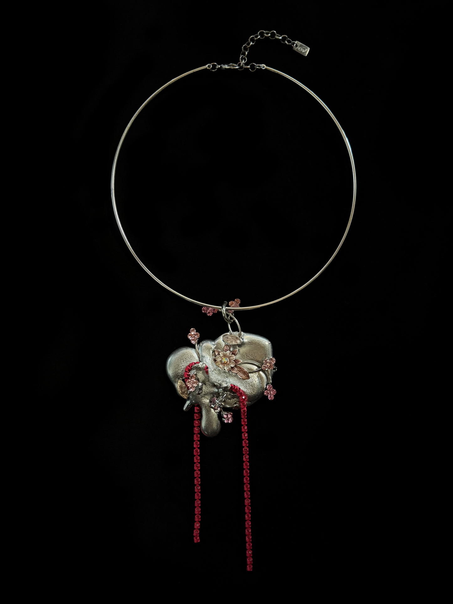 A dreamy, upcycled choker by weARCHIVE featuring a sculptural silver flower pendant, pink rhinestone details, and bright red rhinestone fringe.