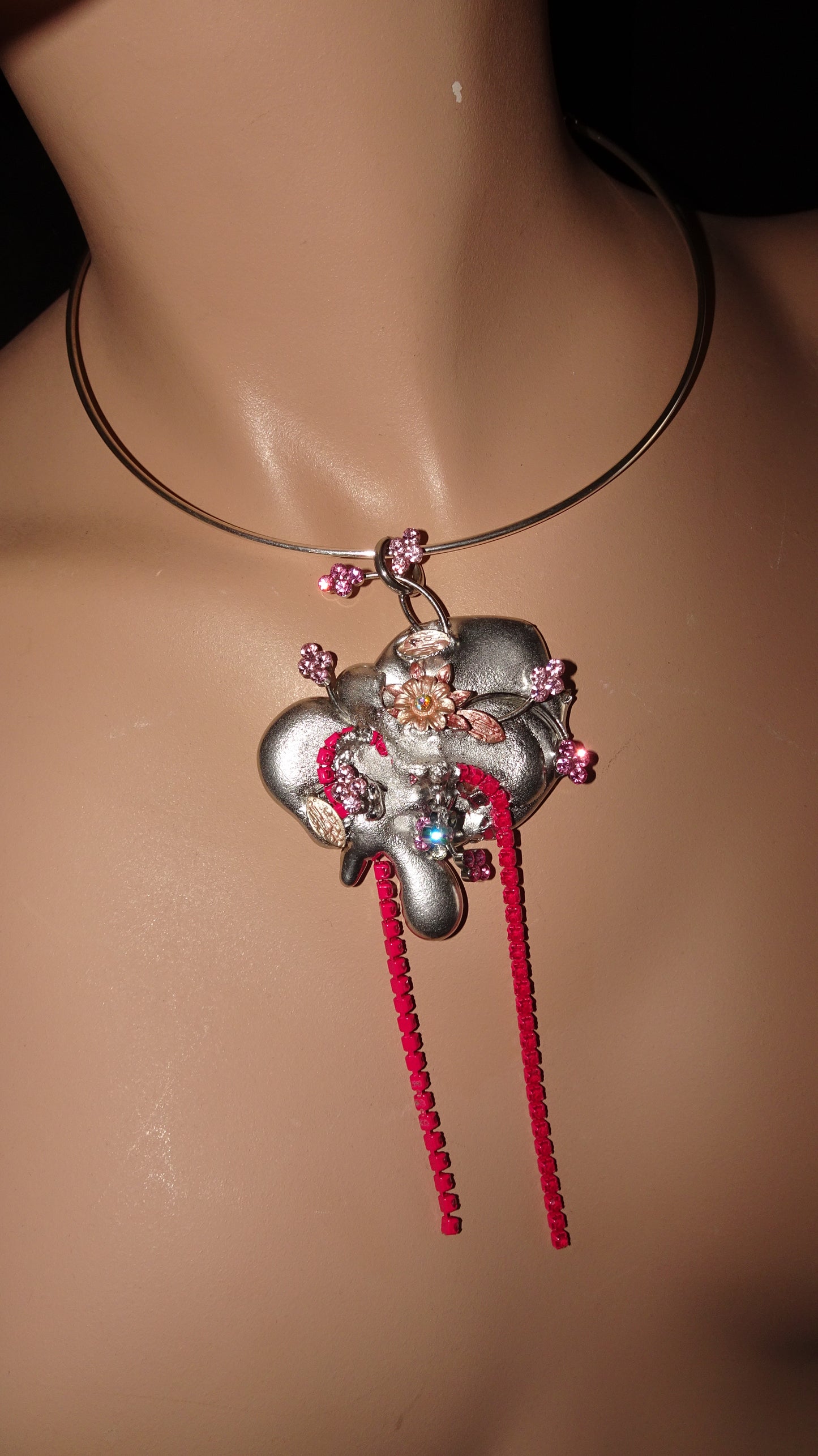 A dreamy, upcycled choker by weARCHIVE featuring a sculptural silver flower pendant, pink rhinestone details, and bright red rhinestone fringe.