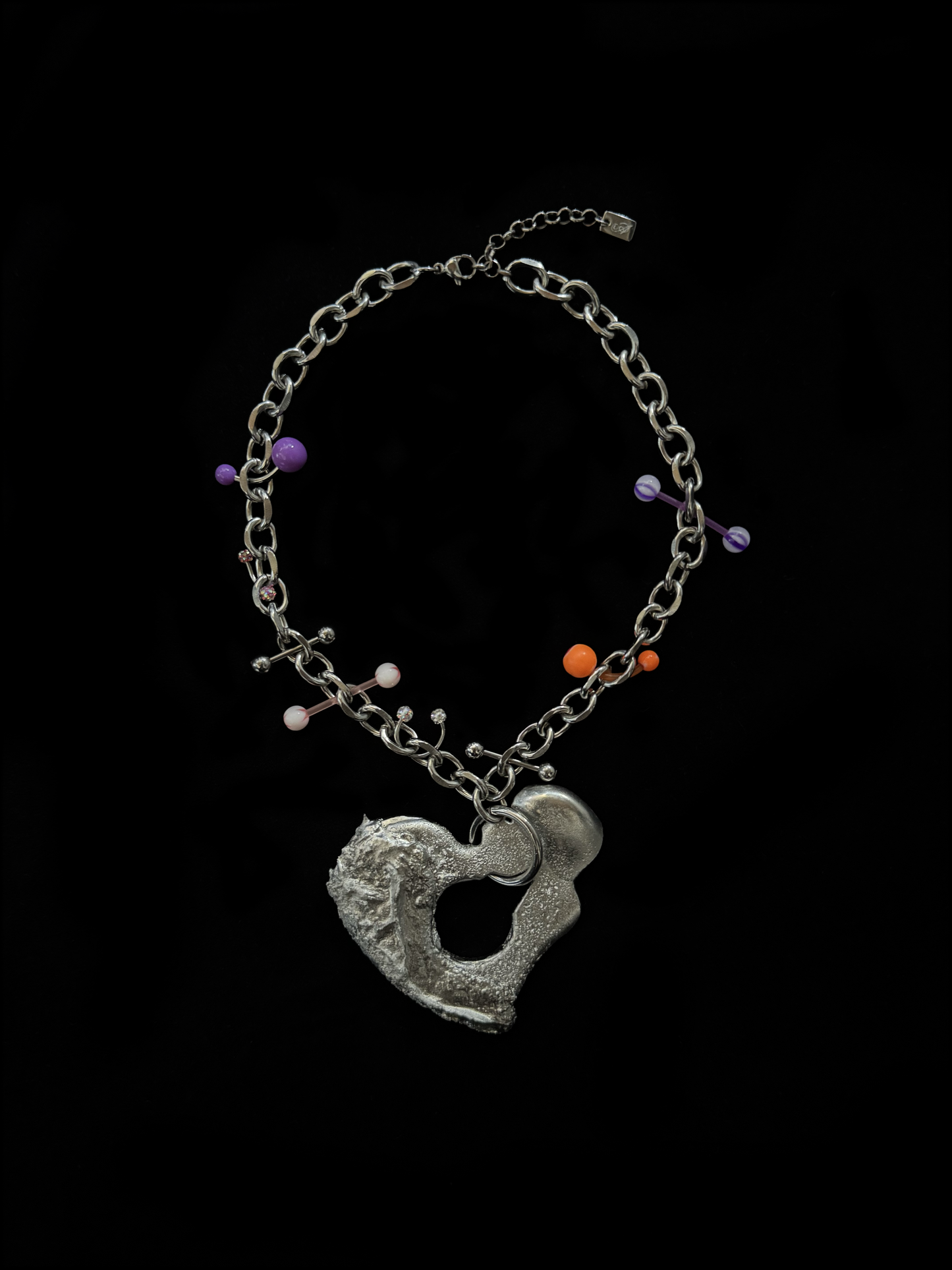 Chunky stainless steel choker by weARCHIVE with a melted sculptural heart pendant and playful purple, orange & pink piercings. Handmade and upcycled.