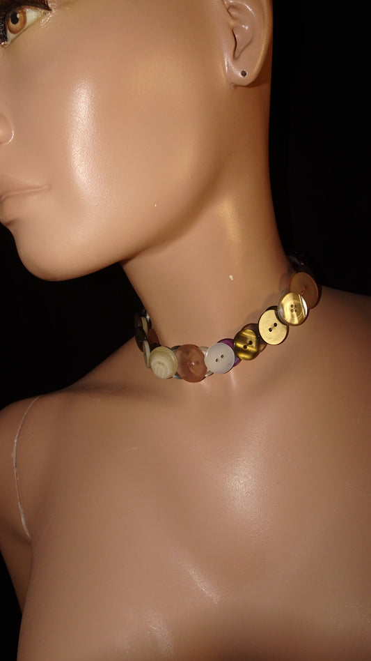 Handmade weARCHIVE choker made of vintage buttons in ivory, peach, burgundy, and metallic tones. Upcycled design with a soft, nostalgic palette.
