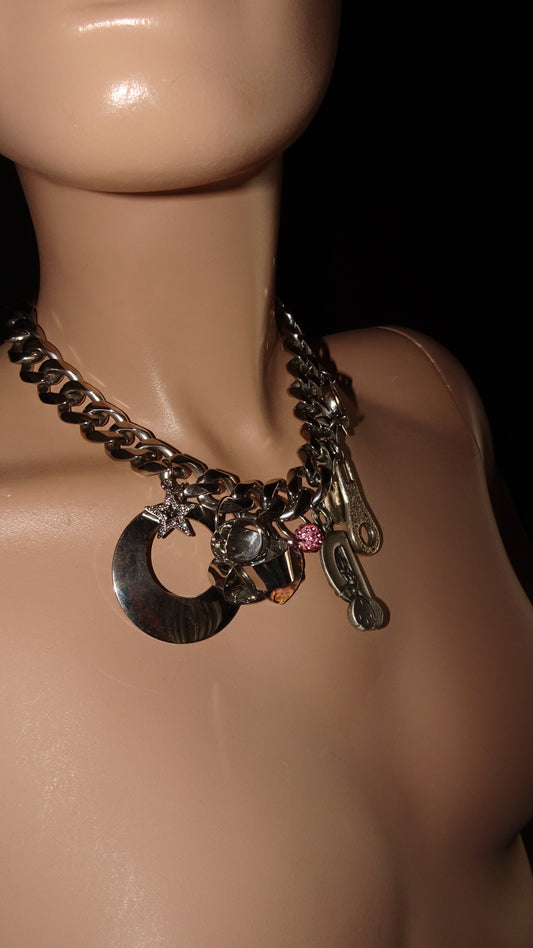 Bold upcycled necklace by weARCHIVE with chunky steel links, vintage charms incl. Diddle, zipper, blue heart pendant & glittery flower