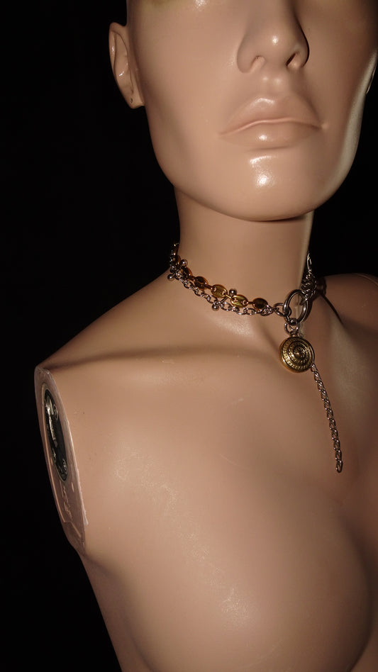 Edgy, upcycled choker by weARCHIVE made from mixed metal chains, belt buckle detail, and a dangling vintage gold-tone button charm with chain.
