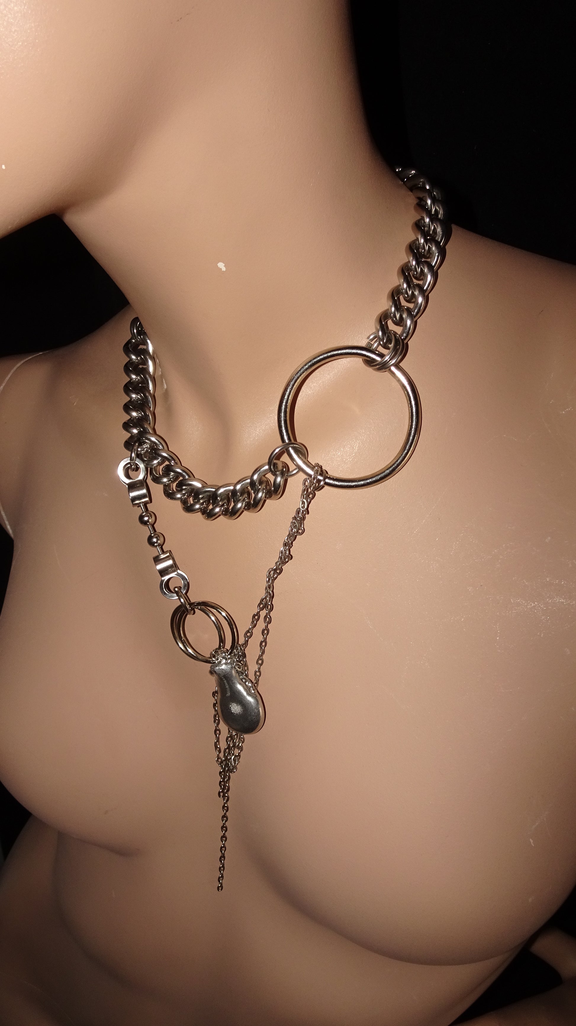 Chunky upcycled necklace by weARCHIVE with silver curb chain, oversized metal rings, and dangling melted drop-shaped charm. Edgy, bold, and handmade.