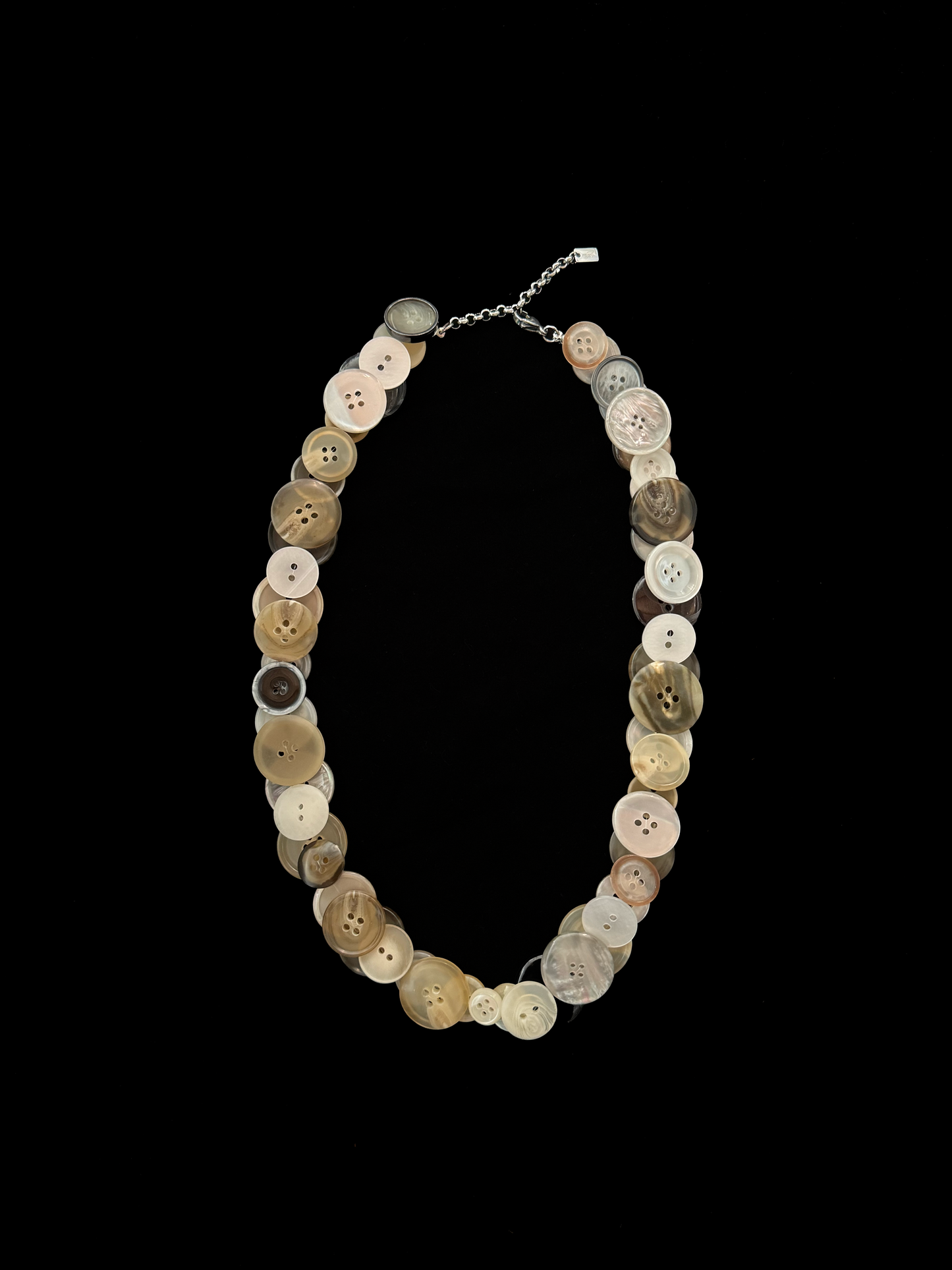 Handmade weARCHIVE necklace made from vintage buttons in tones like ivory, beige, taupe, and soft gold. Upcycled with a soft touch and simple charm.
