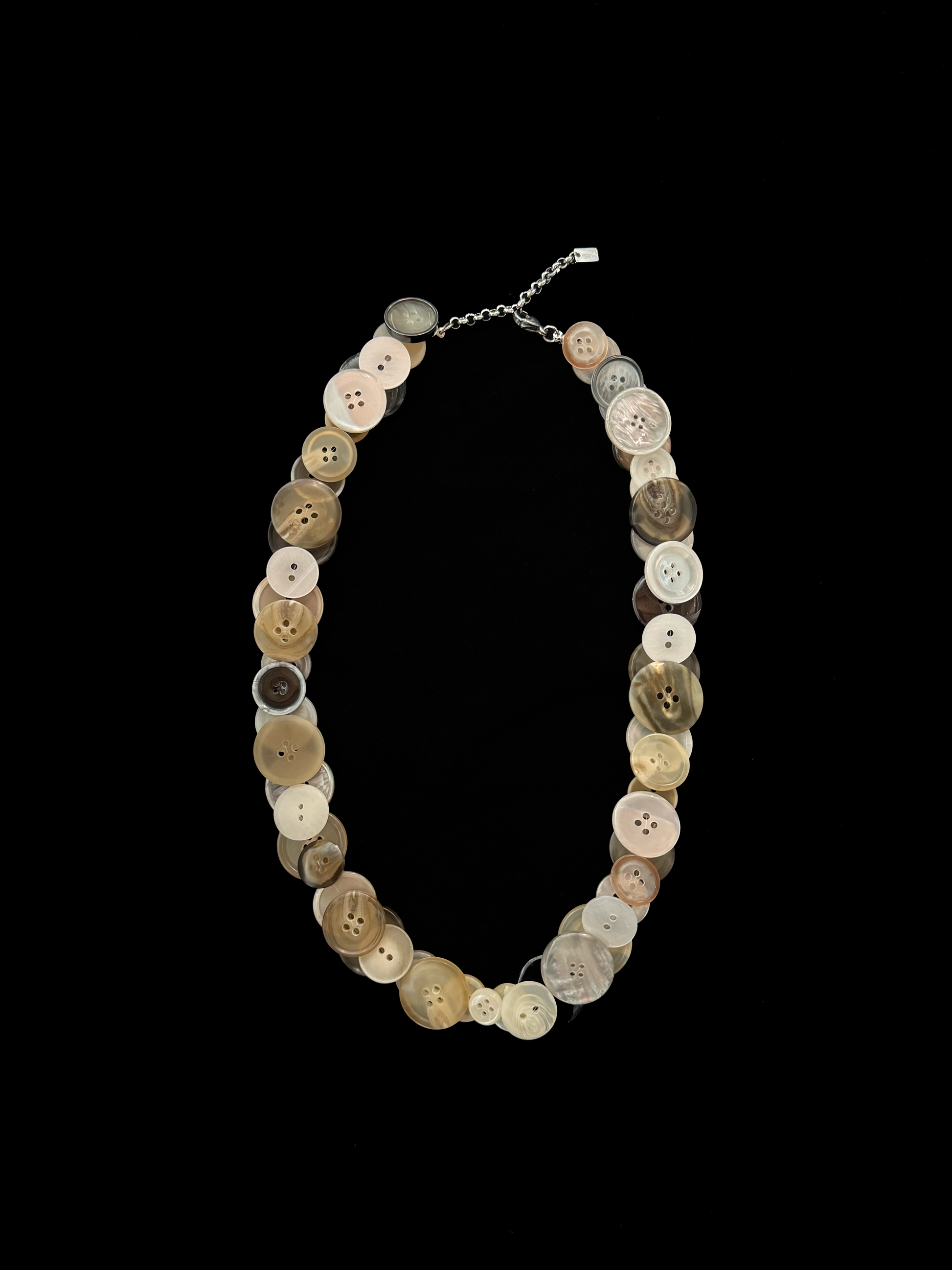 Handmade weARCHIVE necklace made from vintage buttons in tones like ivory, beige, taupe, and soft gold. Upcycled with a soft touch and simple charm.
