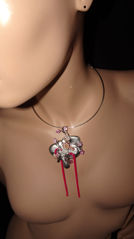 A dreamy, upcycled choker by weARCHIVE featuring a sculptural silver flower pendant, pink rhinestone details, and bright red rhinestone fringe.