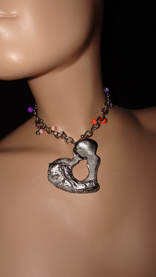 Chunky stainless steel choker by weARCHIVE with a melted sculptural heart pendant and playful purple, orange & pink piercings. Handmade and upcycled.