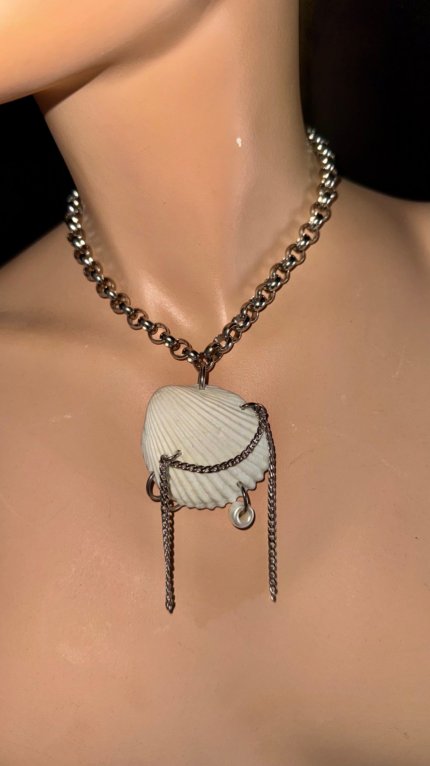 close-up of upcycled shell pendant with draped chain details on stainless steel choker
