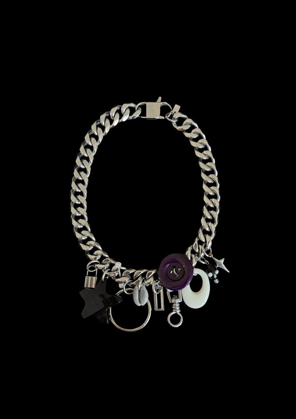 Chain necklace with various charms on a black background