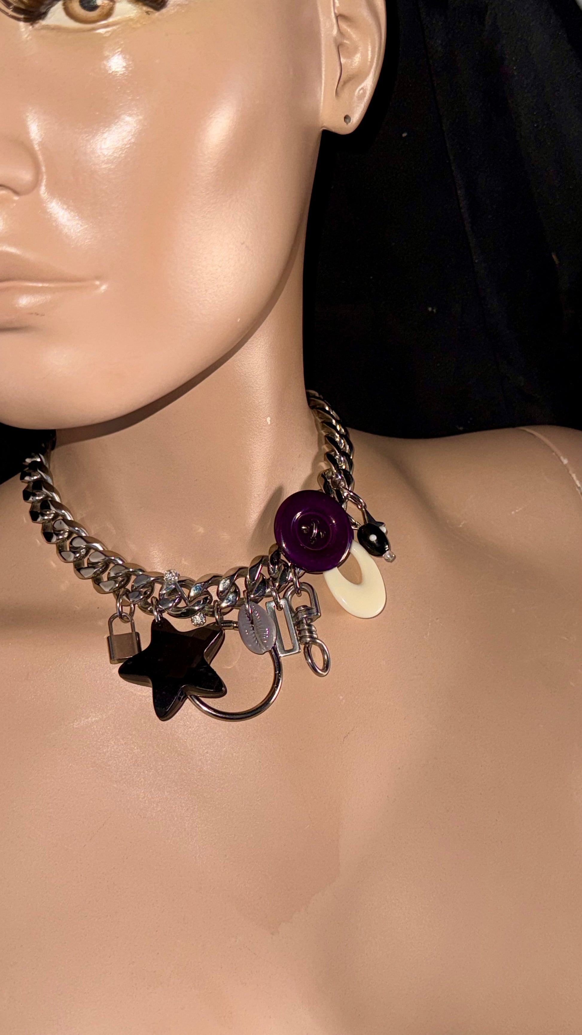 detail stainless steel charm necklace with mixed charms and purple button