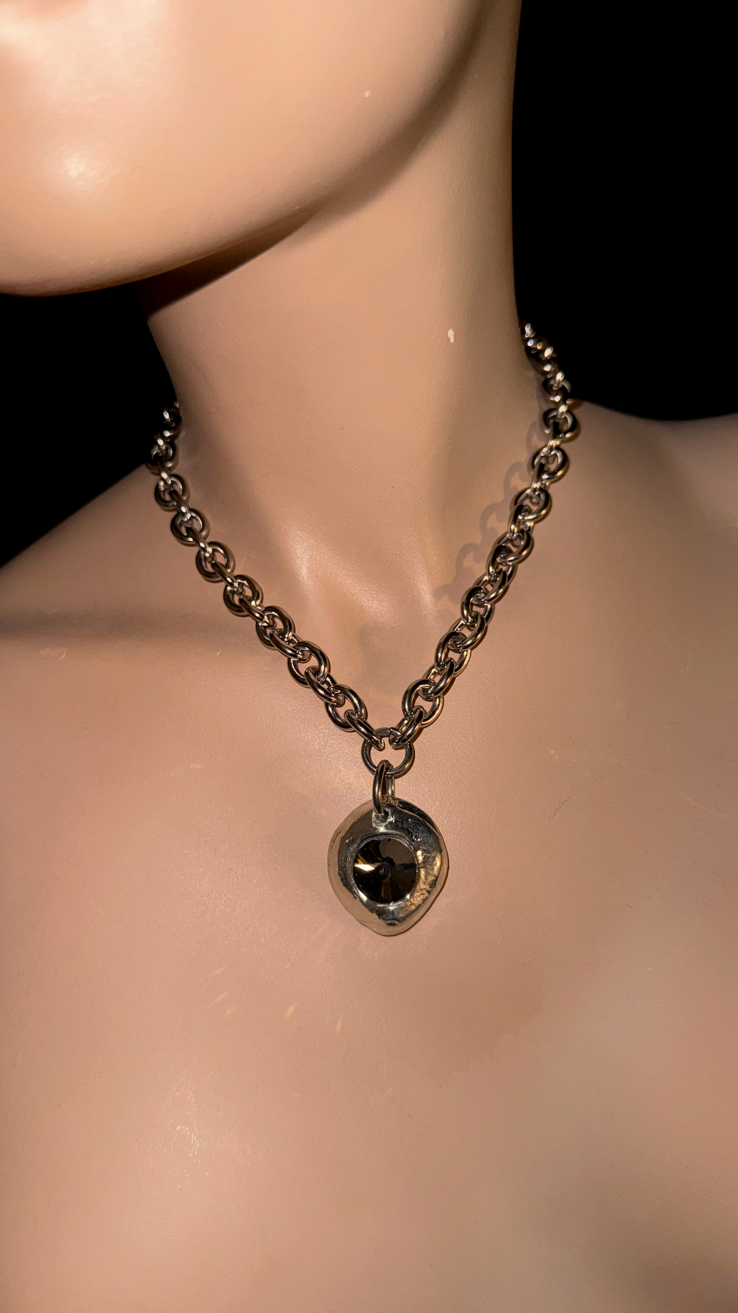stainless steel necklace with melted pendant and black stone detail