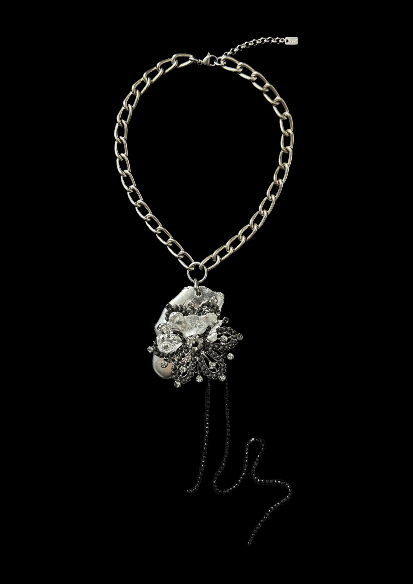 Necklace with floral pendant on a black background