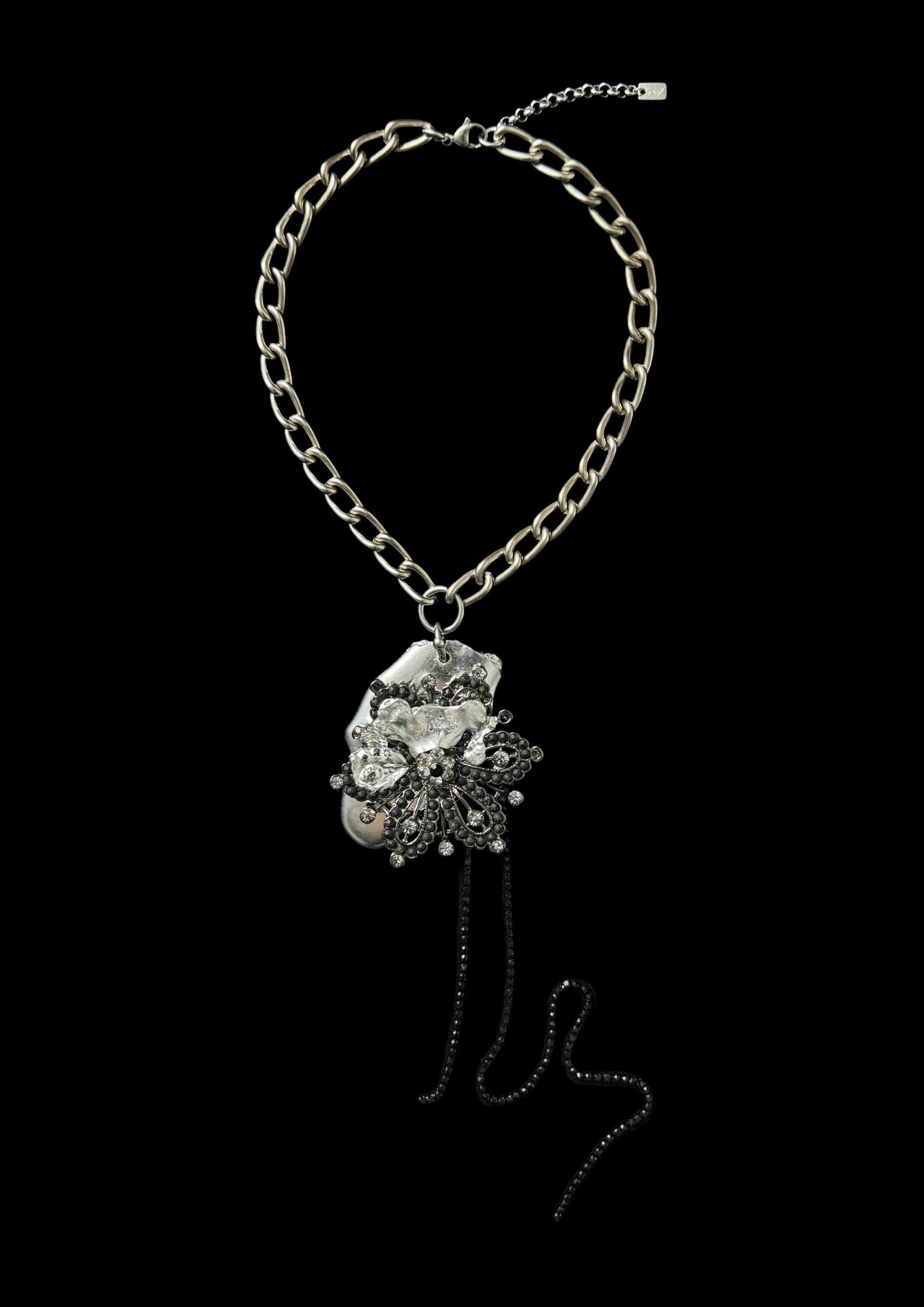 Necklace with floral pendant on a black background