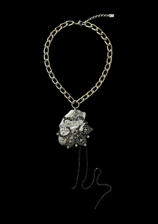 Necklace with floral pendant on a black background