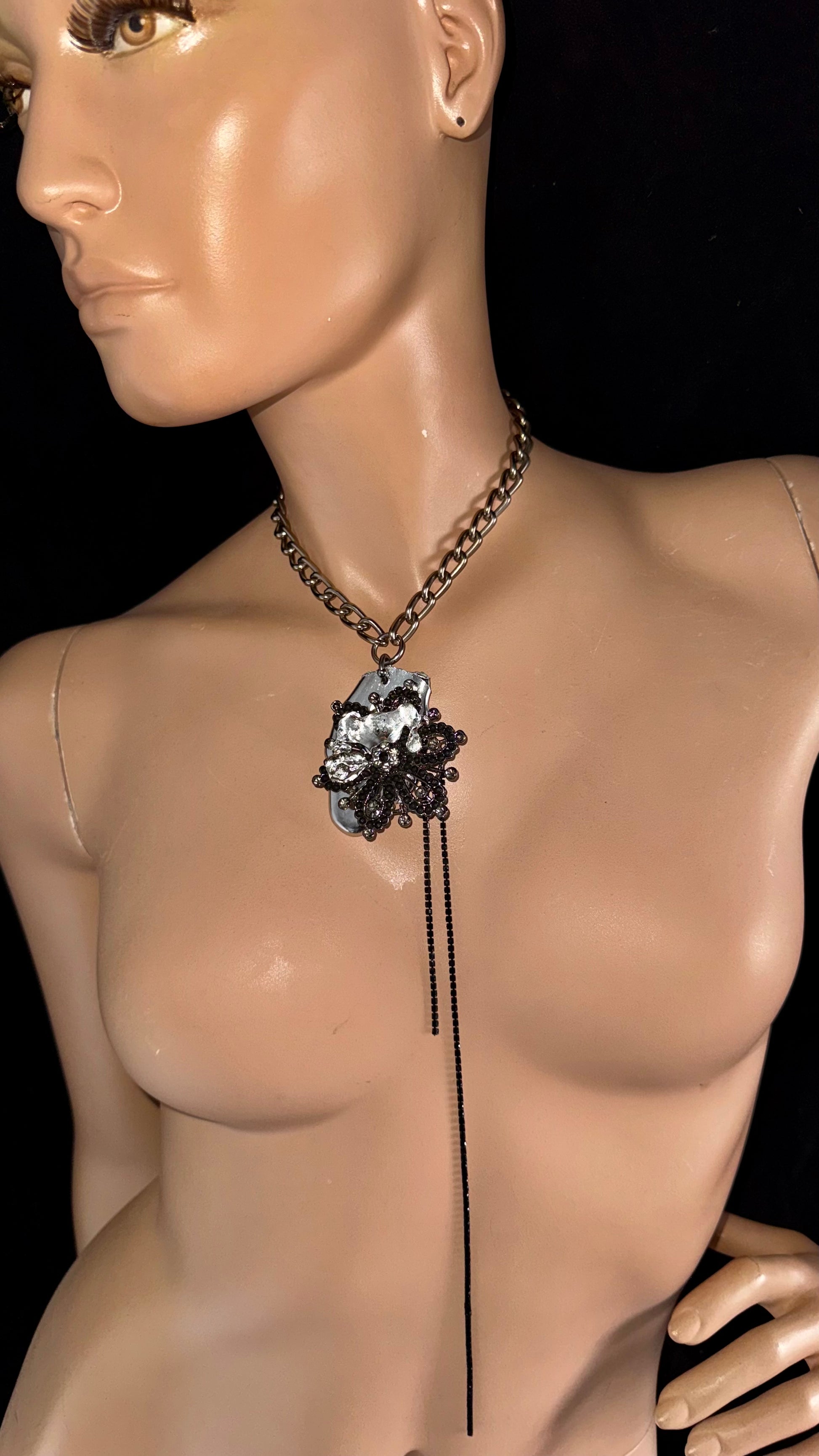 upcycled sculptural necklace with floral brooch and black chain detailing