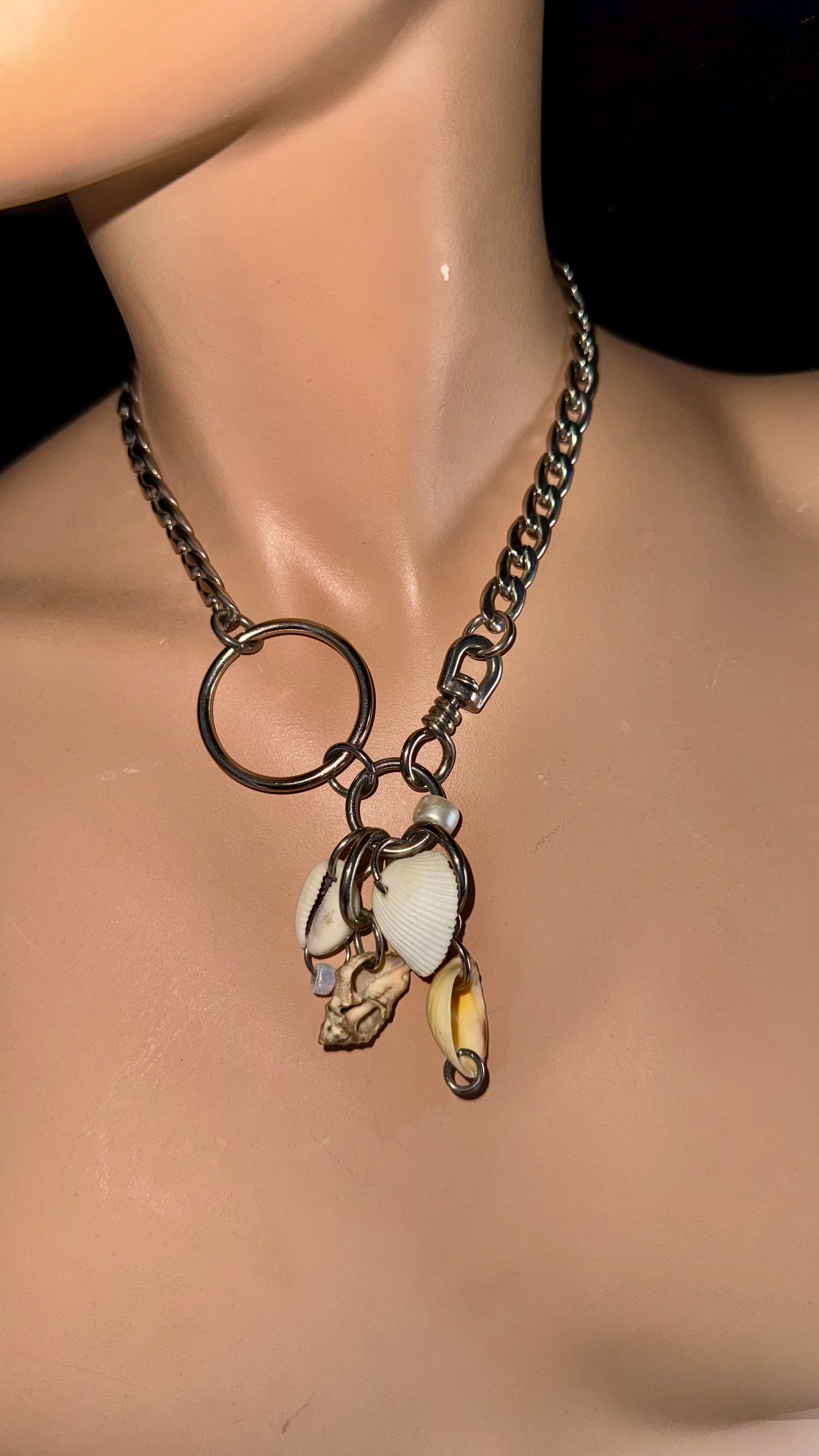 close-up of shell cluster pendant on stainless steel chain necklace